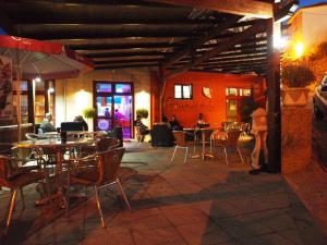 a restaurant with tables and chairs and people sitting at tables at Estrela in Manteigas