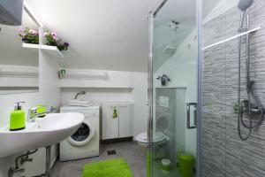 a bathroom with a sink and a washing machine at Split Old Town Apartment in Split