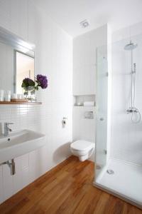 a bathroom with a toilet and a sink and a shower at Bed&Breakfast & Apartment Klafé in Brno