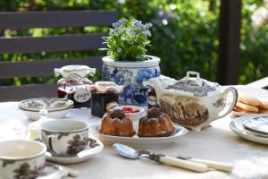 a table with tea cups and pastries on it at B&B Va...lentina in Piavata