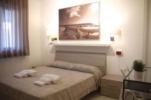 Postel nebo postele na pokoji v ubytování All'Etrusconia Hotel Castagneto Carducci