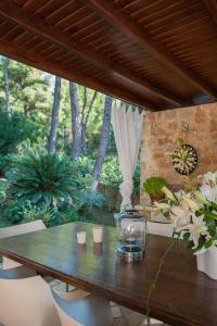 a wooden table with a glass jar on top of it at Naftilos Villa Sani in Sani Beach