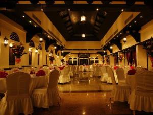 a large banquet hall with white chairs and tables at Arabian Courtyard Hotel & Spa in Dubai +37 photos