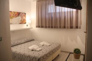 Postel nebo postele na pokoji v ubytování All'Etrusconia Hotel Castagneto Carducci