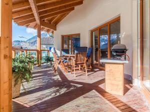 a patio with a table and chairs and a grill at Ferienwohnung Lifinar in Schruns