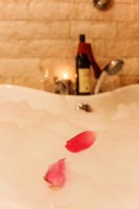 a red leaf on a white sink with a bottle of wine at Sunset Old Town in Ulcinj +42 photos