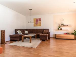 a living room with a brown couch and a table at Ferienwohnung Lifinar in Schruns-Tschagguns