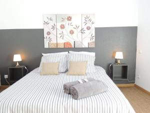 a bedroom with a large white bed with two lamps at Provence Verdon in Tavernes
