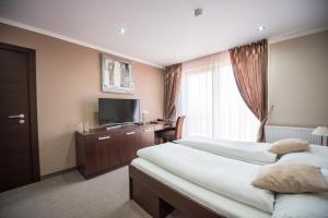Postel nebo postele na pokoji v ubytování Hotel Galanta