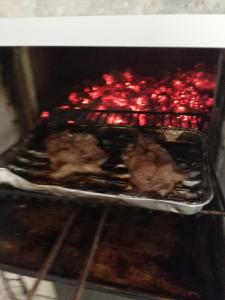 a pan of food is cooking in an oven at Terrazzo su Ibla in Ragusa