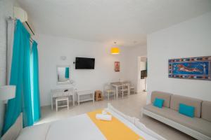 a living room with a couch and a table at Villa Stella Apartments by Estia in Stalís
