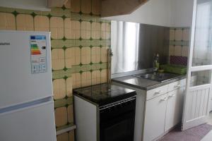 a small kitchen with a stove and a sink at MicroRent Rooms in Braga