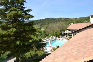 a view of a swimming pool from a house at Logis Hôtel Le Vieil Amandier in Trigance
