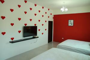 a bedroom with red hearts on the wall at Stick-On B&B in Shunan