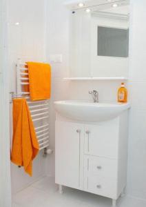 a bathroom with a sink and an orange towel at Willa Rubinia in Iwonicz-Zdrój