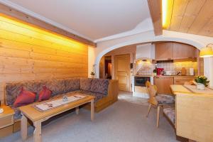 a living room with a couch and a table at Gästehaus Lipp in Mittenwald
