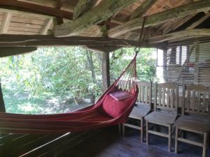 a hammock hanging in a room with chairs at Tanya's House in Kŭrpachevo