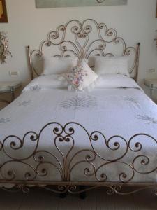 a bed with a white bedspread and pillows at La Casa Di Sissi B&B in Sanremo