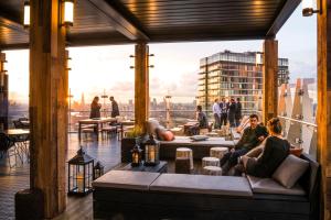 people sitting on a couch on the top of a building at Novotel London Canary Wharf in London