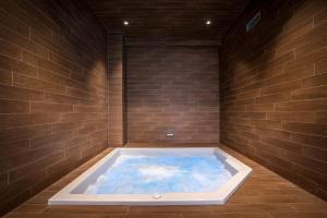 a jacuzzi tub in a brick wall at Best Western Plus Hostellerie Du Vallon in Trouville-sur-Mer