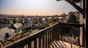 a view of a city from a balcony at Best Western Plus Hostellerie Du Vallon in Trouville-sur-Mer