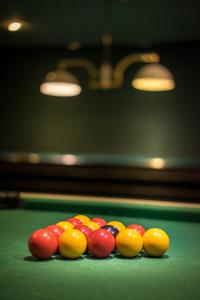 a group of cue balls on a pool table at Best Western Plus Hostellerie Du Vallon in Trouville-sur-Mer