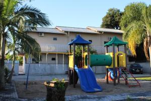 two playground equipment in front of a house at Pousada Bom Futuro in Penha