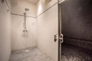 a shower stall with a door in a bathroom at Best Western Plus Hostellerie Du Vallon in Trouville-sur-Mer