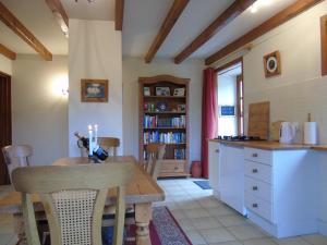 a kitchen with a table and a dining room at Gîte Chez Marot in Varaignes