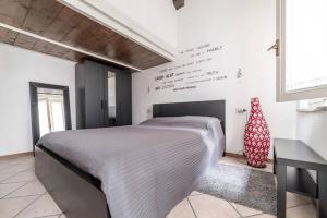 a bedroom with a large bed in a room at Casa della Musica in Parma