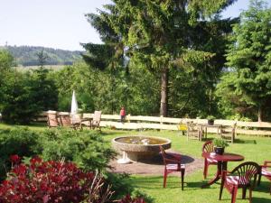 a park with chairs and a fountain in the grass at Pension Haus Am Hirschsprung in Willingen