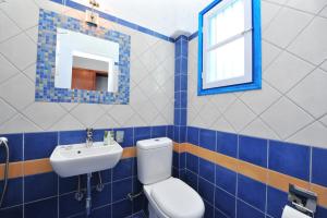 a bathroom with a toilet and a sink and a mirror at St.George Valsamitis in Katapola