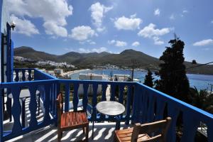 a balcony with a table and chairs and a view at St.George Valsamitis in Katapola