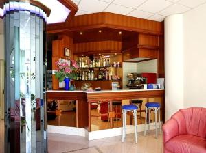 a kitchen with a bar with stools in a room at Residence le Spiagge in Rimini