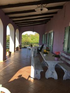 a patio with a table and benches in a building at Agriturismo Renaccio in San Lorenzo Nuovo