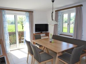 a dining room with a wooden table and chairs at Landgut Wagnerfeld in Altmünster