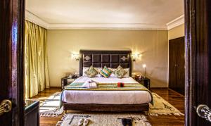 Postel nebo postele na pokoji v ubytování Palm Plaza Marrakech