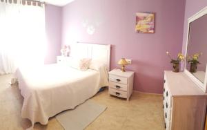a bedroom with a bed and a mirror and a dresser at Apartamentos Andrea in Belmonte de Miranda