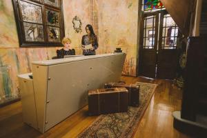 a woman standing at a counter in a room with luggage at Vila Katharina in Braşov