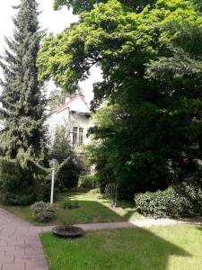a garden with a house and trees and a walkway at Apartment near Villa Turgenev in Baden-Baden