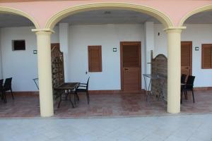 a patio with chairs and tables in a building at Residence Hotel Torresilvana in Vieste