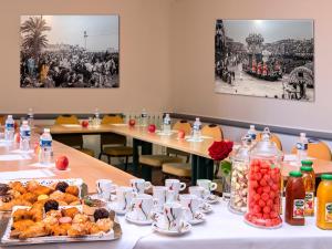 a table with plates of food on a table at Hôtel Le Royal Promenade des Anglais in Nice