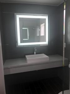 a bathroom with a sink and a mirror at La Bonita Inn Motel in Long Beach