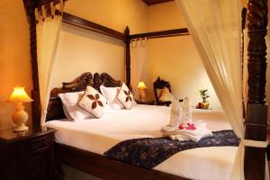 מיטה או מיטות בחדר ב-Alam Jogja Resort Mitra RedDoorz