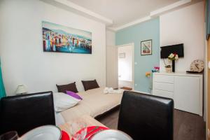 a living room with a bed and a couch at Apartment Simone in Split