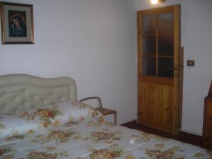 Postel nebo postele na pokoji v ubytování B&B L'Arcobaleno