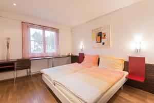 
a hotel room with a large bed and a large window at Hotel Thorenberg in Luzern
