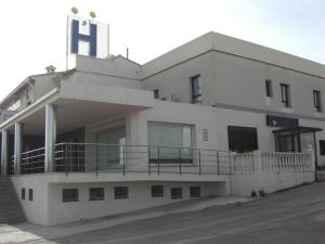 een wit gebouw met een balkon aan de zijkant bij Hostal Millán in Segorbe