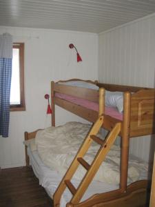 a bunk bed in a room with a ladder at Seljestad Cottages in Skare