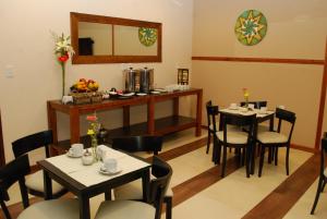 a dining room with tables and chairs and a mirror at Hotel Ideal Resto Bar in Colorado River